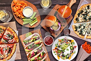 Healthy plant based fast food table scene. Overhead view on a wood background.