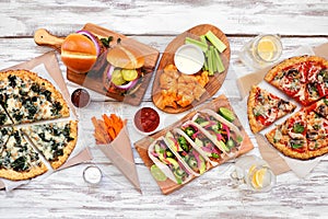 Healthy plant based fast food table scene. Top view on a white wood background.