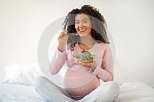 Healthy Pregnancy Nutrition. Cheerful Black Pregnant Woman Eating Fresh Vegetable Salad