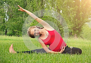 Healthy pregnant woman doing yoga in nature