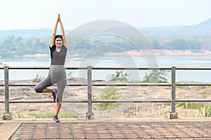 Healthy pregnant woman doing yoga nature outdoors. Prenatal yoga is a way to maintain a healthy mind and body to increase