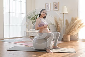 Healthy pregnant woman exercising and doing prenatal yoga, meditation, working out, yoga, pregnancy concept