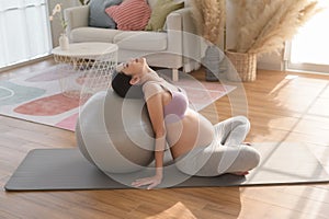 Healthy pregnant woman exercising and doing prenatal yoga, meditation, working out, yoga, pregnancy concept