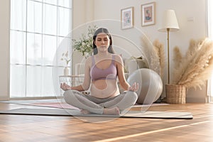 Healthy pregnant woman exercising and doing prenatal yoga, meditation, working out, yoga, pregnancy concept