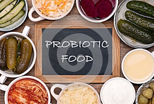 Healthy probiotic fermented foods in cups and bowls photo
