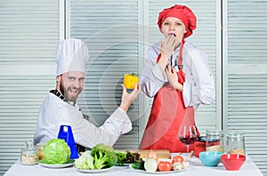 Healthy proposal. Join healthy lifestyle. Man chef offer yellow pepper to girl. Just try. Will you eat pepper