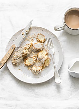 Healthy protein snack, breakfast - peanut butter, seeds, banana nut bites on a light background