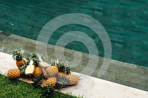Healthy Raw Organic Food. Fresh Ripe Pineapples near Pure Water In Swimming Pool.