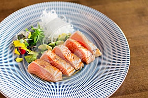 Healthy raw salmon tataki dish.