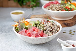 Healthy raw tuna bowl with quinoa and vegetales. Buddha bowl photo