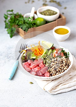 Healthy raw tuna bowl with quinoa and vegetales. Buddha bowl photo