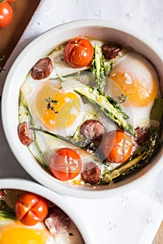 Healthy and rich breakfast with baked eggs and vegetables