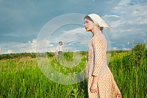 The healthy rural life. The woman and man in the green field