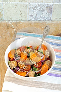 Healthy salad bowl with cuscus, chicken, tangerine and sesame seeds