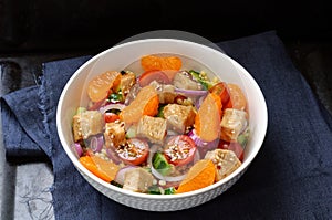 Healthy salad bowl with cuscus, tomatoes, cucumber, chicken, tan