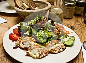 Healthy salad and bread on wood table