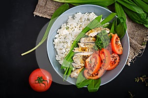 Healthy salad with chicken, tomatoes, wild garlic and rice