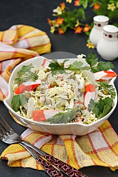 Healthy salad with Chinese cabbage, canned peas and crab sticks