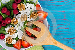 Healthy salad with fresh berries and feta cheese