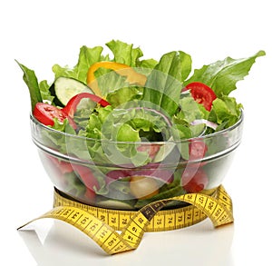 Healthy salad and a measuring tape