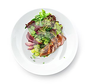 Healthy salad with medium rare beef steak, pear, grapes, lettuce, arugula, and sauce in plate isolated on white background.