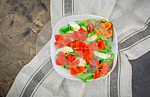 Healthy salad with nasturtium flowers