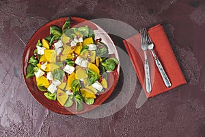 Healthy salad with persimmon, doucette lambs-lettuce, cornsalad, feld salad and feta cheese. Fitness food. Superfoods Vitamin