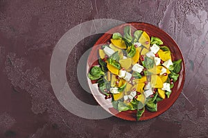 Healthy salad with persimmon, doucette lambs-lettuce, cornsalad, feld salad and feta cheese. Fitness food, superfoods vitamin