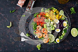 Healthy salad plate. Fresh seafood recipe. Grilled shrimps and fresh vegetable salad - avocado, tomato, black beans, red cabbage a