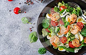 Healthy salad plate. Fresh seafood recipe. Grilled shrimps and fresh vegetable salad and egg. Grilled prawns. Healthy food. Flat l