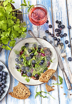 Healthy salad with rocket and blueberries