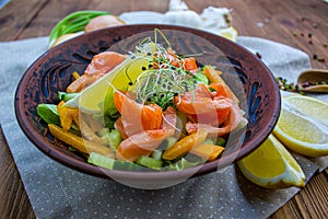 Healthy salad with salmon and quail eggs