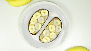 Healthy sandwich with Crunchy Peanut Butter and Banana Slices on a White plate