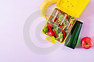 Healthy school lunch box with beef sandwich and fresh vegetables