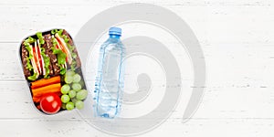 Healthy school lunch box with sandwich and fresh vegetables