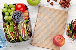 Healthy school lunch box with sandwich and fresh vegetables