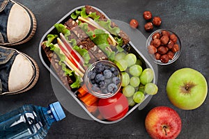 Healthy school lunch box with sandwich and fresh vegetables