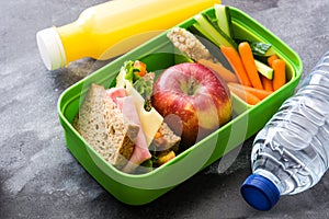 Healthy school lunch box: Sandwich, vegetables ,fruit and juice