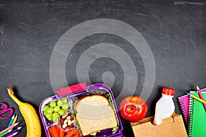 Healthy school lunch box and school supplies bottom border on a chalkboard background