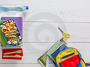 Healthy school lunch box on white wood background, top view