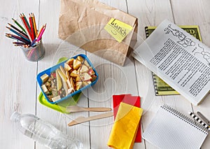 Healthy school lunch box on white wood background, top view