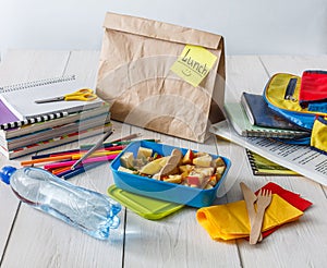 Healthy school lunch in box on white wood table background