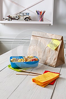 Healthy school lunch in box on white wood table background