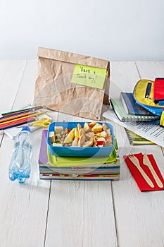 Healthy school lunch in box on white wood table background