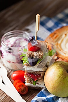 Healthy school lunch with a sandwich, fresh fruits, bun and milk