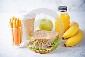 Healthy school lunch with a sandwich, fresh fruits and juice