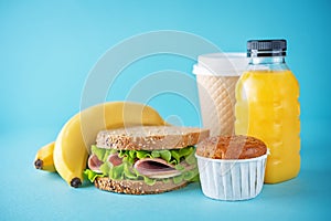 Healthy school lunch with a sandwich, fresh fruits and juice