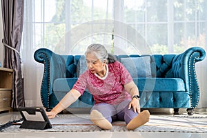 Healthy Senior woman workout online from home