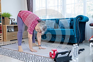 Healthy Senior woman workout online from home