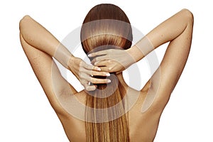 Healthy Shiny Long Hair in Tale. Beautiful Girl holding her Hair in hand. Back view on white. Hairstyle with strong Hair